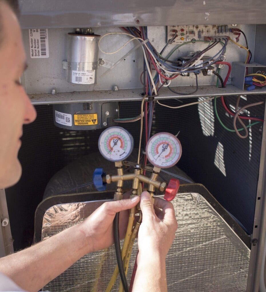 A Milestone HVAC technician works on a residential HVAC unit.