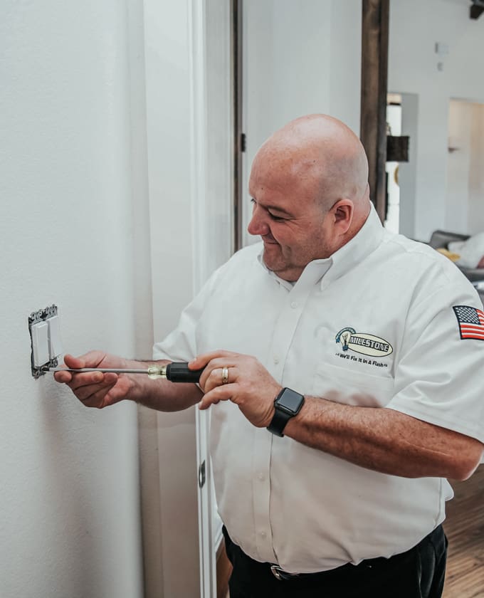 Milestone technician working on a light switch