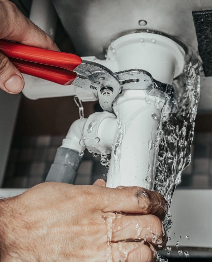 Milestone technician repairing a leaking pipe